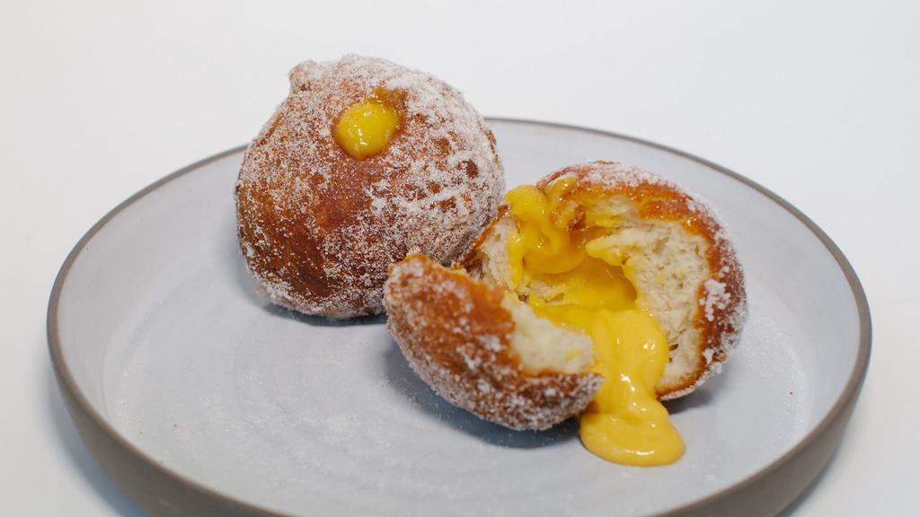 Malasadas · 2 Hawaiian-style donuts filled with a house-made passsion-fruit curd, tossed in sugar (vegetarian)