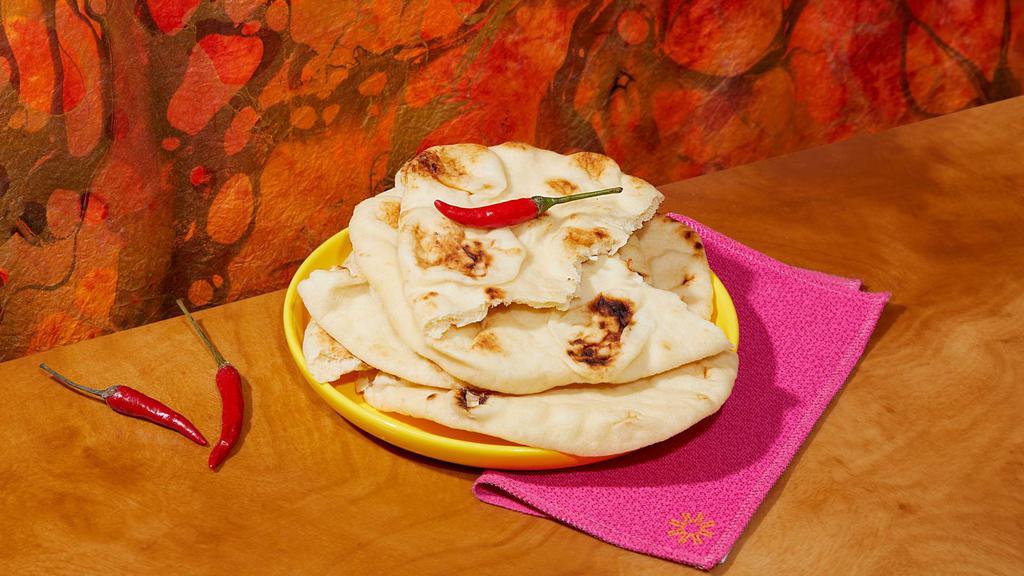 Naan · Tandoor oven baked flatbread.