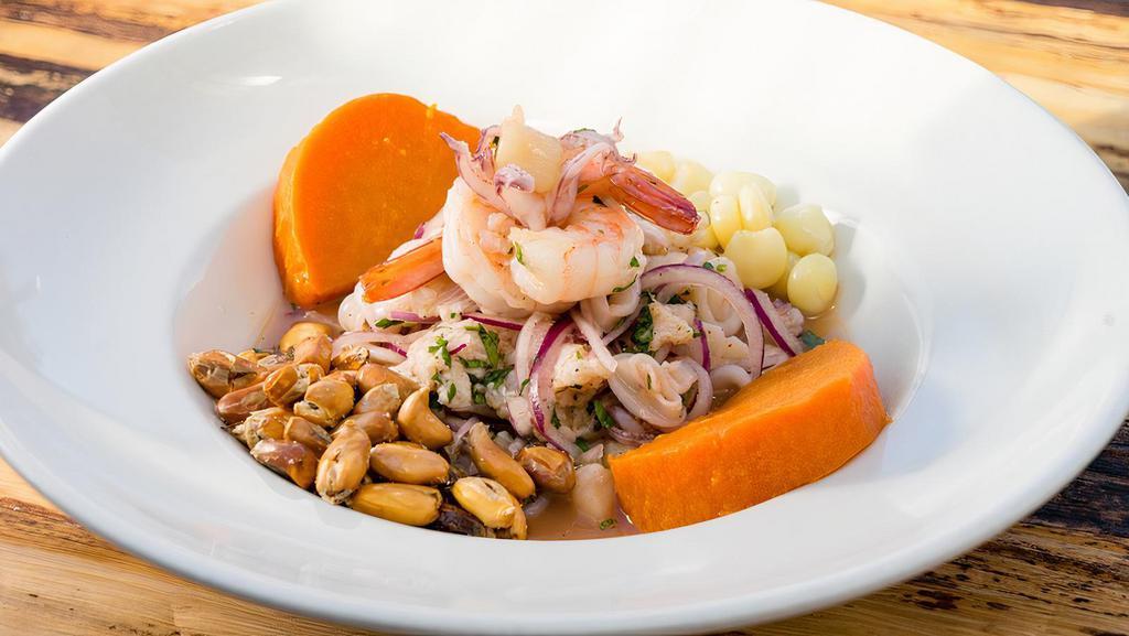 Ceviche - Mixed Seafood · A spicy dish of mixed seafood or fresh raw fish cooked and cured in lime juice, rocoto chili and spices, served cold with boiled sweet potatoes, fresh and toasted peruvian corn.