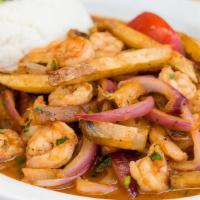 Saltado de Camarones · Stir fried shrimp, onions, tomatoes, fried potatoes, cilantro and soy sauce, served with gar...