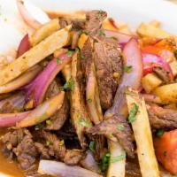 Lomo Saltado · A beloved Peruvian classic! Stir fried Certified Angus Beef, onions, tomatoes, fried potatoe...