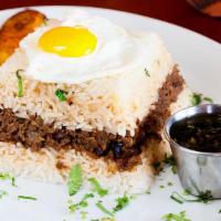 Tapado a lo Pobre · A traditional Peruvian comfort food, ground Certified Angus Beef stew made with raisins, oli...