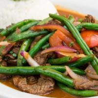 Vainitas de Carne · Stir fried Certified Angus Beef, green beans, onions, tomatoes, cilantro and soy sauce, serv...