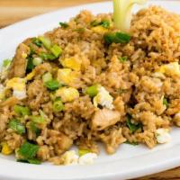 Chaufa de Pollo · Peruvian style chicken fried rice mixed with scrambled eggs, green onions and soy sauce.