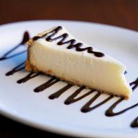 Cheesecake w/ Maracuya · N.Y. Cheesecake topped with passion fruit and chocolate syrup.