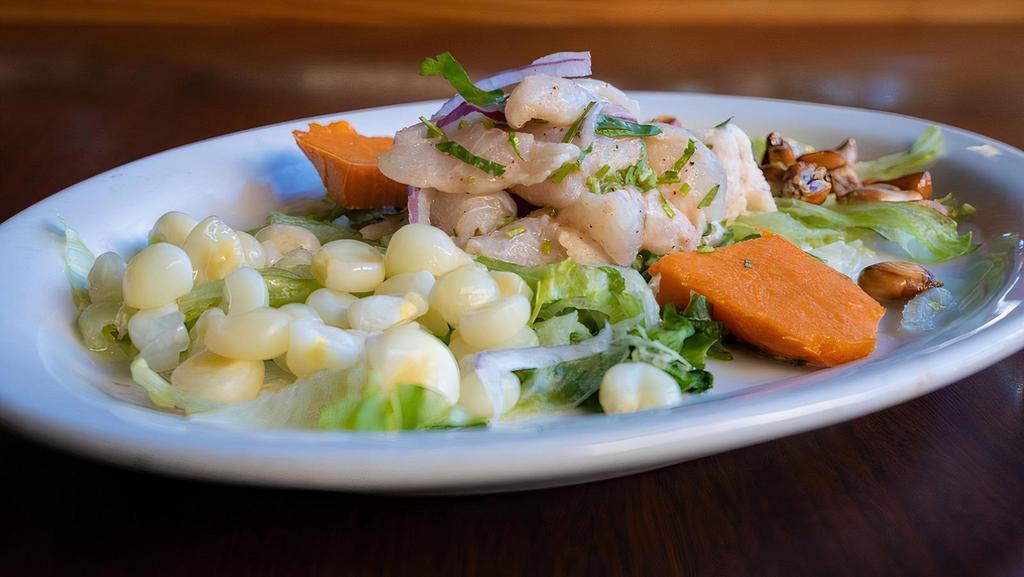 Cevichito - Fish · A spicy dish of fresh raw fish or mixed seafood cooked and cured by quickly marinating in lime juice, Rocoto chili and spices, served cold with boiled sweet potatoes, fresh and toasted Peruvian corn.