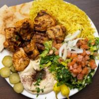 Chicken Kabab · Grill marinated 6 cubed chicken, served with rice, salad, fresh onion, grill Tomatoes and hu...