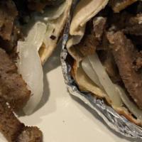 Beef Shawarma Wrap · Beef shawarma, tahini sauce, lettuce, tomatoes, fresh onion, pickled and parsley .