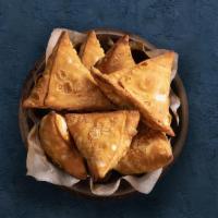 Vegetable Samosa · Perfectly fried crispy pastry dumplings filled with a mix of aromatic herbs and mashed potat...