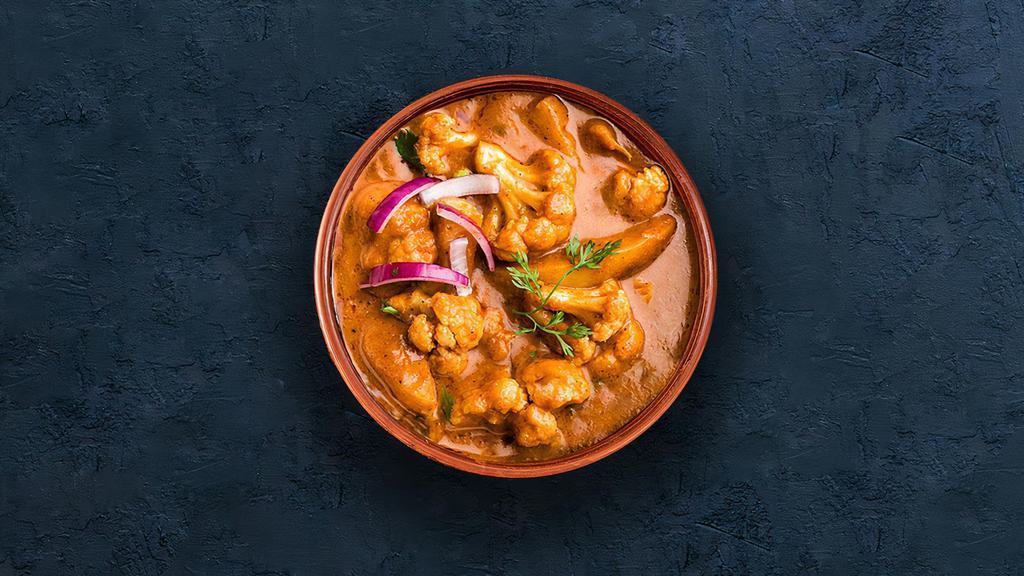 Aloo Gobi · Diced potatoes and cauliflower simmered with onion, tomato and cashew curry paste.