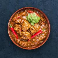 Goat Curry · Tender goat meat morsels cooked to perfection with traditional Indian herbs.