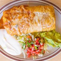Super Chimichanga · A deep fried burrito stuffed with meat, rice and beans inside of it. Garnished with sour cre...
