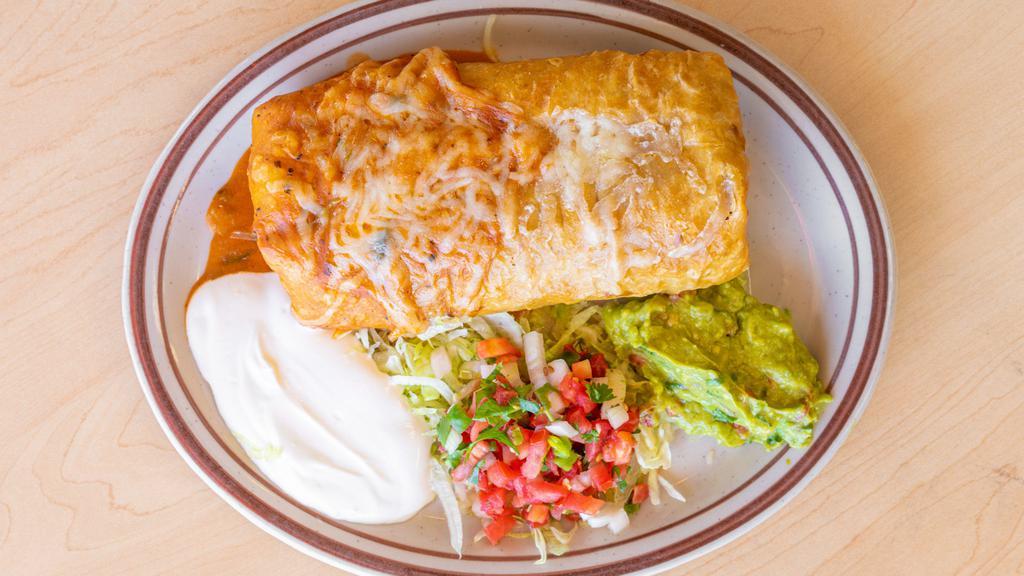 Super Chimichanga · A deep fried burrito stuffed with meat, rice and beans inside of it. Garnished with sour cream, guacamole and pico de gallo. With your choice of meat shredded beef or chicken, carnitas, carne asada, al pastor and chile Verde.