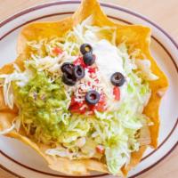Taco Salad · An edible, crispy flour tortilla shell, layered with beans and your choice of beef, chicken ...