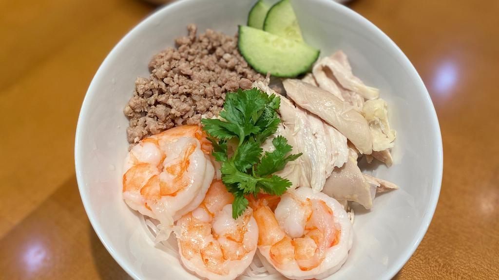 Dry Hu Tieu · Rice noodles served with chicken, shrimp, ground pork, house-made fish cake, cucumbers and crispy shallots in a garlic soy