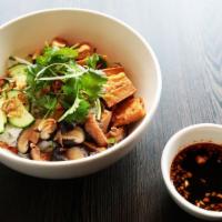 Dry Hu Tieu (Vegan) · Rice noodles served with fried tofu, mushroom, cucumbers, and crispy shallots in a garlic soy.