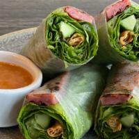Nem Noung Cuon · Grilled pork wrapped in rice paper with a crispy roll, lettuce, mint, & cucumber served with...