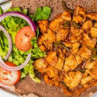 15. Dorho (Chicken) Tibs · Diced tender fresh chicken breast stir-fried in seasoned butter, hot pepper, onion, and garlic