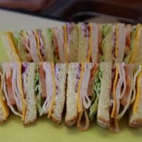 33-Turkey Club Sandwich · Cheese, mayonnaise, mustard, lettuce, tomato, onion, and pickle.