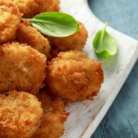 Mac Bites · Don't want to commit to a whole bowl of mac? Our bite sized snack features sourdough breaded...