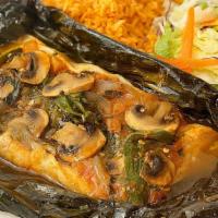 Filete al Vapor · Fish Filet wrapped with a banana leaf with tomato, onion, jalapeños, mushroom,  cilantro and...