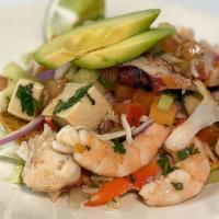Tostada Mixta · Mixed fish ceviche, cooked shrimp, octopus, abalone, crab, and baby clams, tomato, onion, ci...