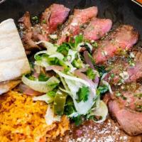 Carne Asada · Roasted steak served with rice, beans and salad