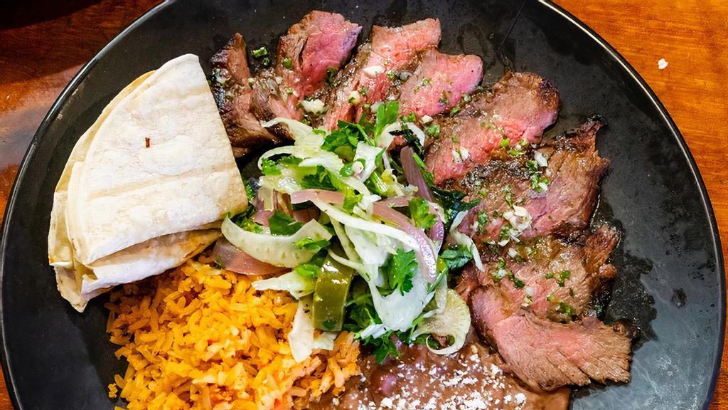 Carne Asada · Roasted steak served with rice, beans and salad