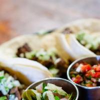 Taco Trio · Onions and cilantro / salsa roja / rice & beans