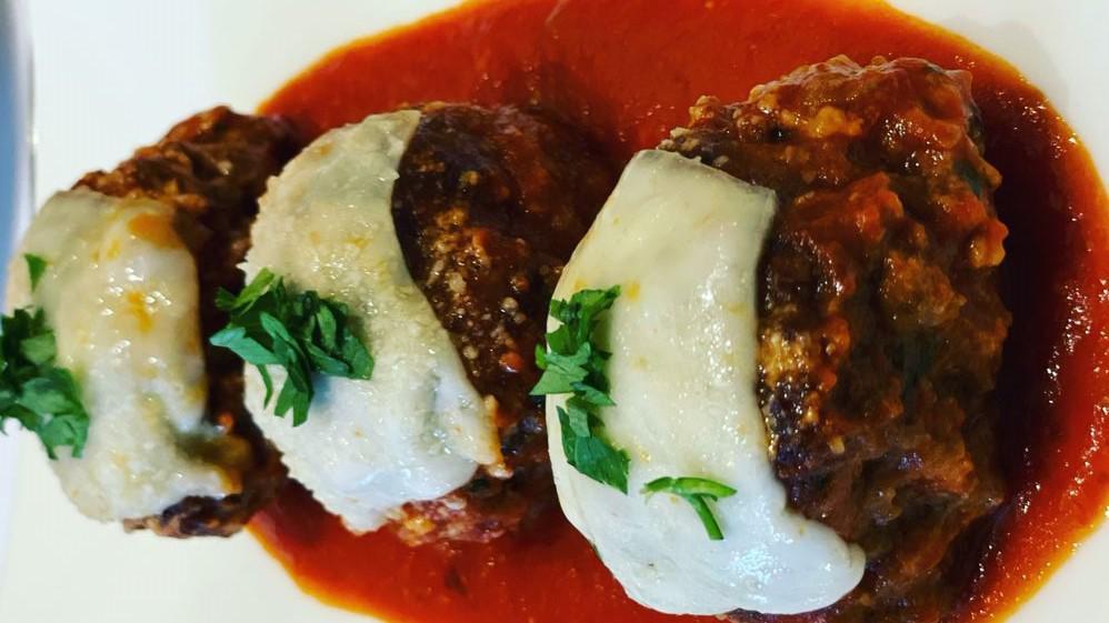 Homemade Meatballs · Beef Meatballs served with mozzarella cheese and basil over tomato sauce.
