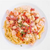 Roma Fettuccini · Fresh homemade pasta, sautéed rock shrimp, bay scallops, sundried tomatoes and light roasted...