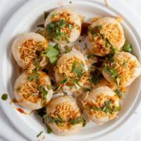 Sev Puri · Semolina puff filled with onion, sev, tamarind, and mint sauce.
