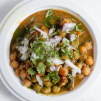 Samosa Chaat · Potato and peas stuffed pastry, chickpea curry, onion, tamarind, and mint sauce.
