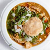 Chole Papdi Chaat · Flat semolina chips, chickpea curry, onion, tamarind, and mint sauce.