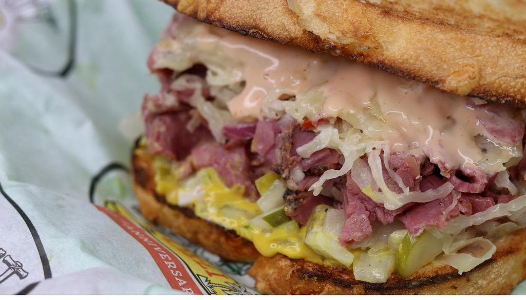 Righteous Reuben · Pastrami, Swiss, Italian dressing, onions, sauerkraut, mustard, pickles, & 1000 island sauce. Toasted garlic bread.