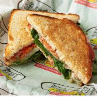 Cali Caprese · Melted monterey jack cheese, balsamic vinaigrette, pesto, tomatoes & spinach on toasted garl...