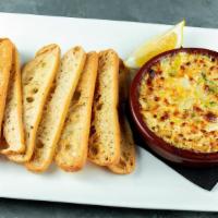Famous Spicy Artichoke Dip · Blend of artichokes, roasted red peppers, jalapenos and parmesan with crostini for dipping.