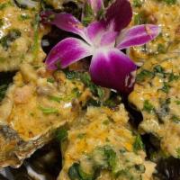 Chargrilled Oysters Dozen · Goose point oysters grilled to perfection topped with garlic butter, creole seasoning and pa...