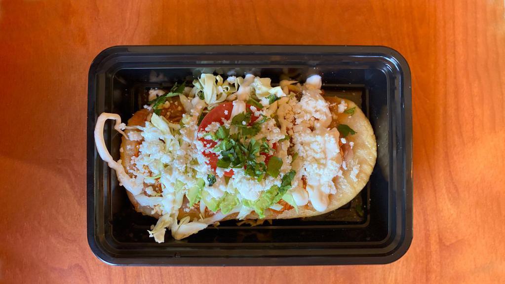 Huarache · Corn masa cake with choice of topping, re-fried beans, cabbage, sour cream, queso fresco, avocado and tomato.