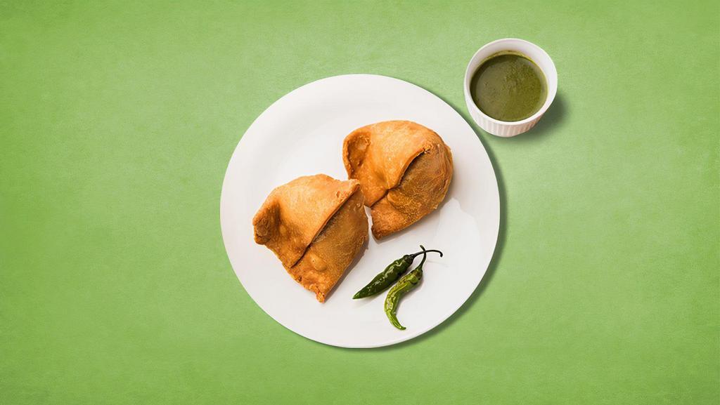 Splendid Samosa · Triangular pastry with a savory filling of spiced potatoes, peas, and lentils. Served with cilantro and tamarind relish.
