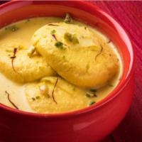 Rasmalai · Soft Paneer Balls immersed in chilled Creamy Milk garnished with Pistachio.