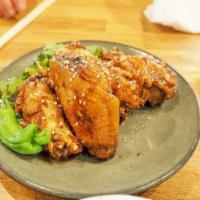 Spicy Umami Chicken Wings · Fried chicken wings glazed with Ippudo's special housemade spicy umami sauce and sprinkled w...