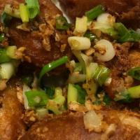GAI TOD  · Battered deep fried chicken wings topped with fried garlic green onions.