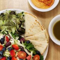 Moroccan Plate · Hummus, warm pita, three dolmas, mix greens, tomatoes, cucumber, olives, feta cheese and bal...