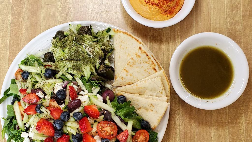 Moroccan Plate · Hummus, warm pita, three dolmas, mix greens, tomatoes, cucumber, olives, feta cheese and balsamic vinaigrette