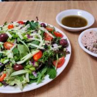 Nikoise Salad · Tuna Salad over a mountain of mix greens, olives, tomatoes, cucumber, onions, and feta chees...
