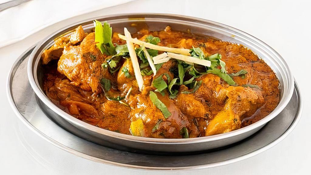 Karahi Chicken · Chicken cooked in butter gravy with bell peppers, onions, tomatoes, and spices.