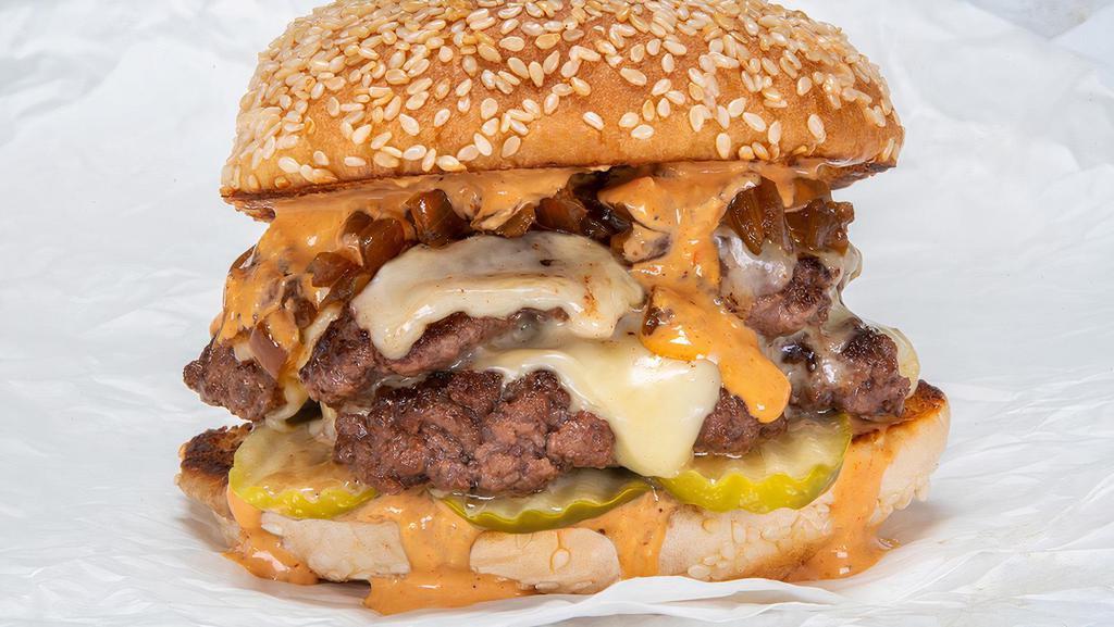 Double Smash Burger · Two black Angus beef patties, white American cheese, pickles, diced onions, caramelized onions ＆ secret sauce, served on a sesame seed bun.