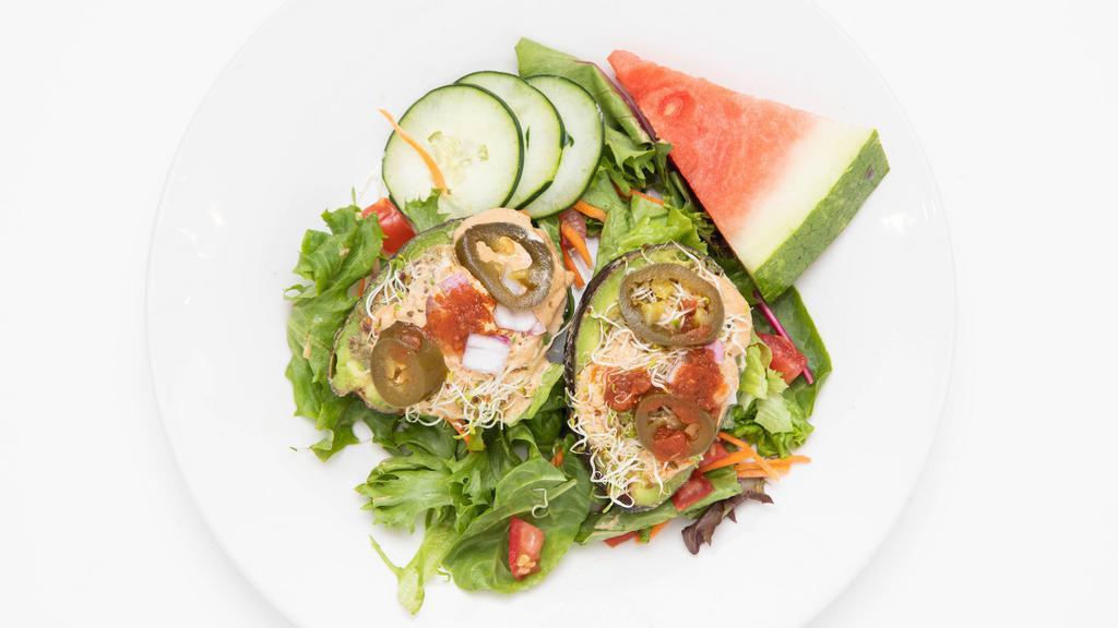 Stuffed Avocado · Raw-Vegan. Sunflower seed pate, cashew cheese, tomatoes, onions sprouts, and spicy tomato dressing.