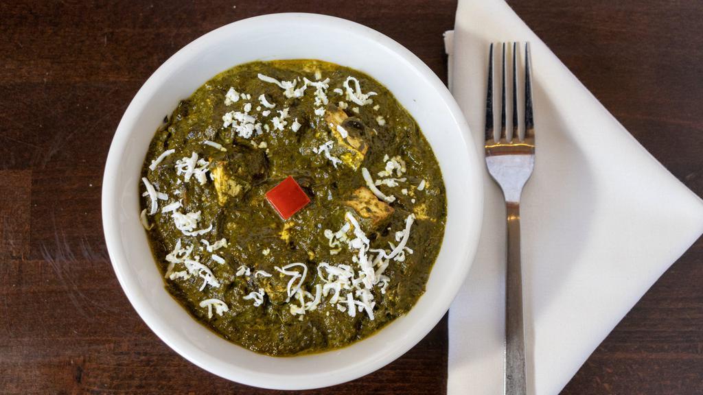 Palak Paneer (Spinach & Cheese)   · Homemade cottage cheese cubes in a mildly spiced semi pureed Spinach with ginger, garlic, onions and tomatoes.
Gluten Free.